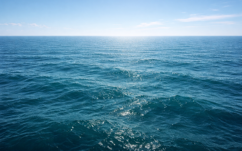 Deep teal ocean with gentle waves and sunlight — representing the steady flow of regulatory change intelligence